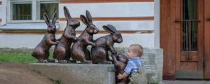 Cute kid trying to help a statue