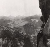 Two ladies do high kicks while posing atop Overhanging Rock at Glacier Point in the Yosemite National Park, 1900