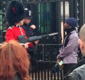 A Coldstream Guard pointing his bayonet at a man after he argued with the police officer and tried to force his way into the palace on Friday.