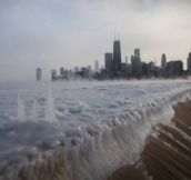 A frozen Lake Michigan sits still in front of Chicago skyline