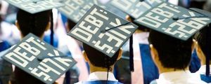 Students wear how much debt they are in on their graduation caps.