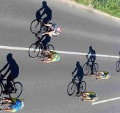 Cyclists As Shadows To Their Bikes