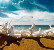 Sea Foam Crashes Over The Sand