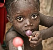 Child Offers To Share A Lollipop With The Photographer, Amazing Photo By Emil Leonardi