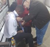 Older Man Helps Young Man Tie A Tie