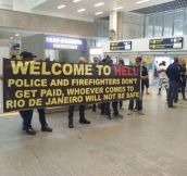 Brazilian cops and firefighters protest in the airport for incoming tourists