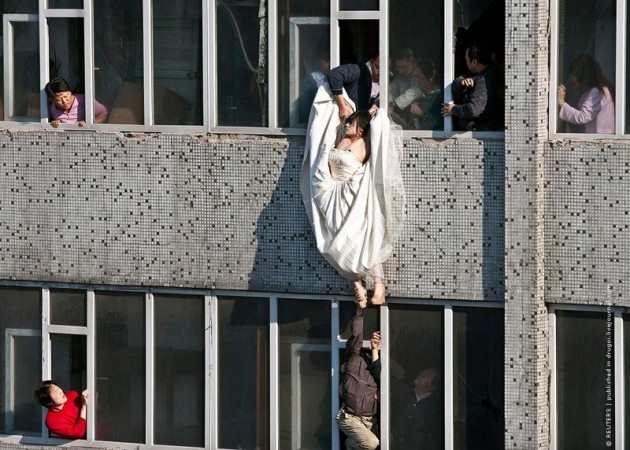 image0163 630x450 Man Saves Bride Jumping From Top Story Window