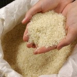 Dipping your hand into a deep bag of uncooked rice