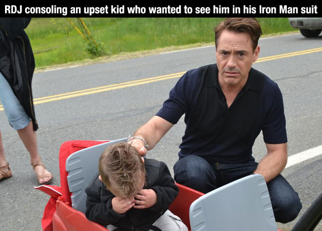 Robert Downey, Jr. Consoling an upset kid who wanter to see him in his Iron Man suit...