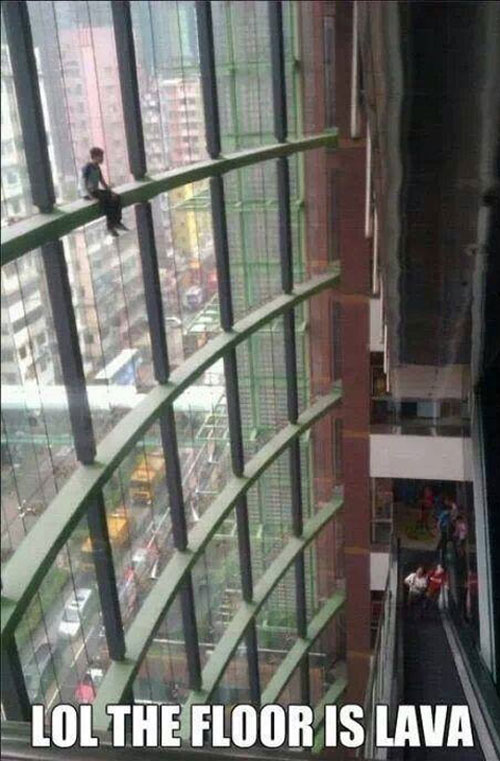 funny-guy-shopping-mall-window-climbing