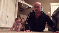 Dad and daughter do push-ups together...