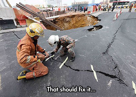 funny-firefighter-tape-huge-hole-street