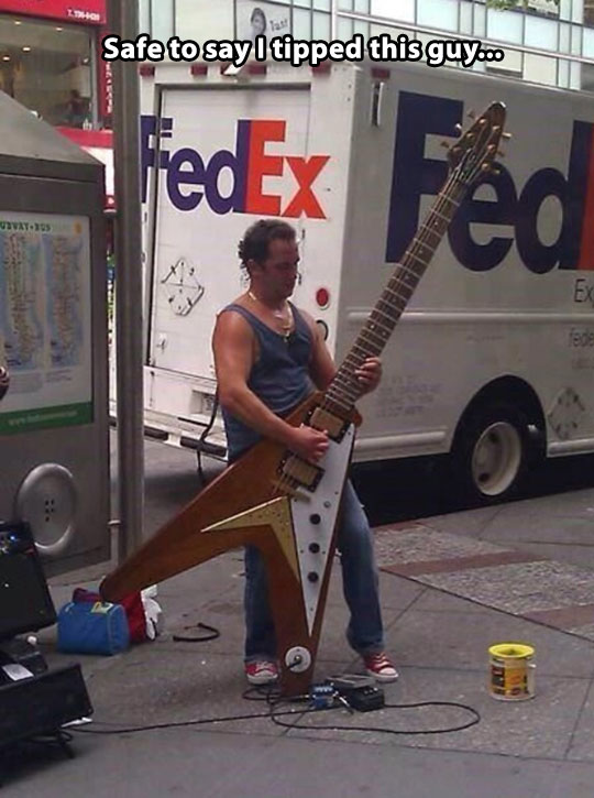 funny-guy-street-giant-guitar-playing.jpg